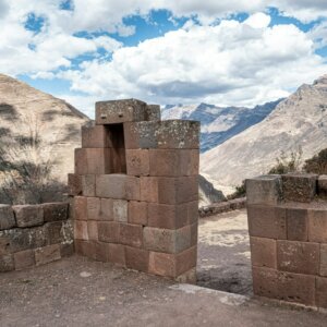 a view of a mountain range from a stone wall