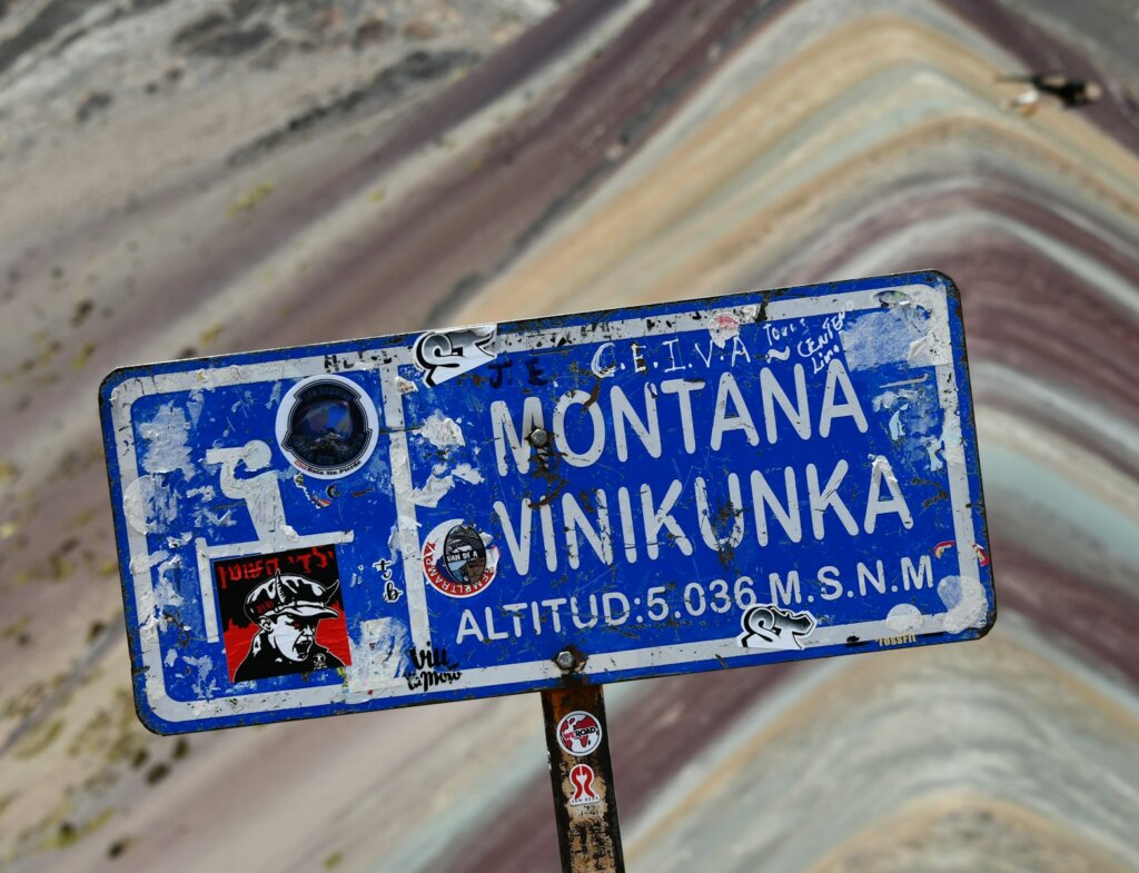 a blue street sign sitting on the side of a road